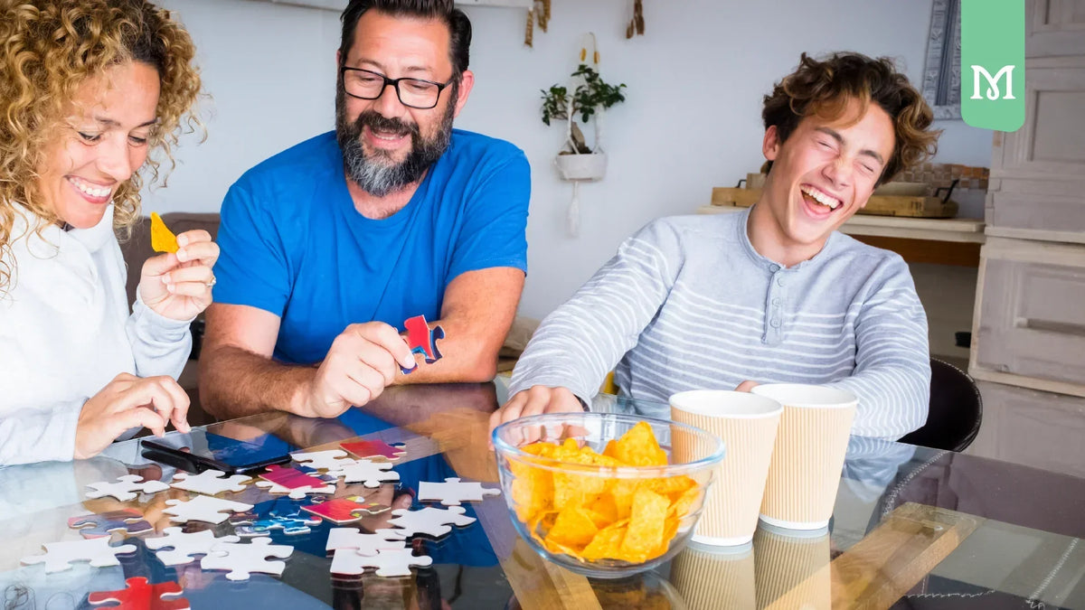 family laughing and making a puzzle