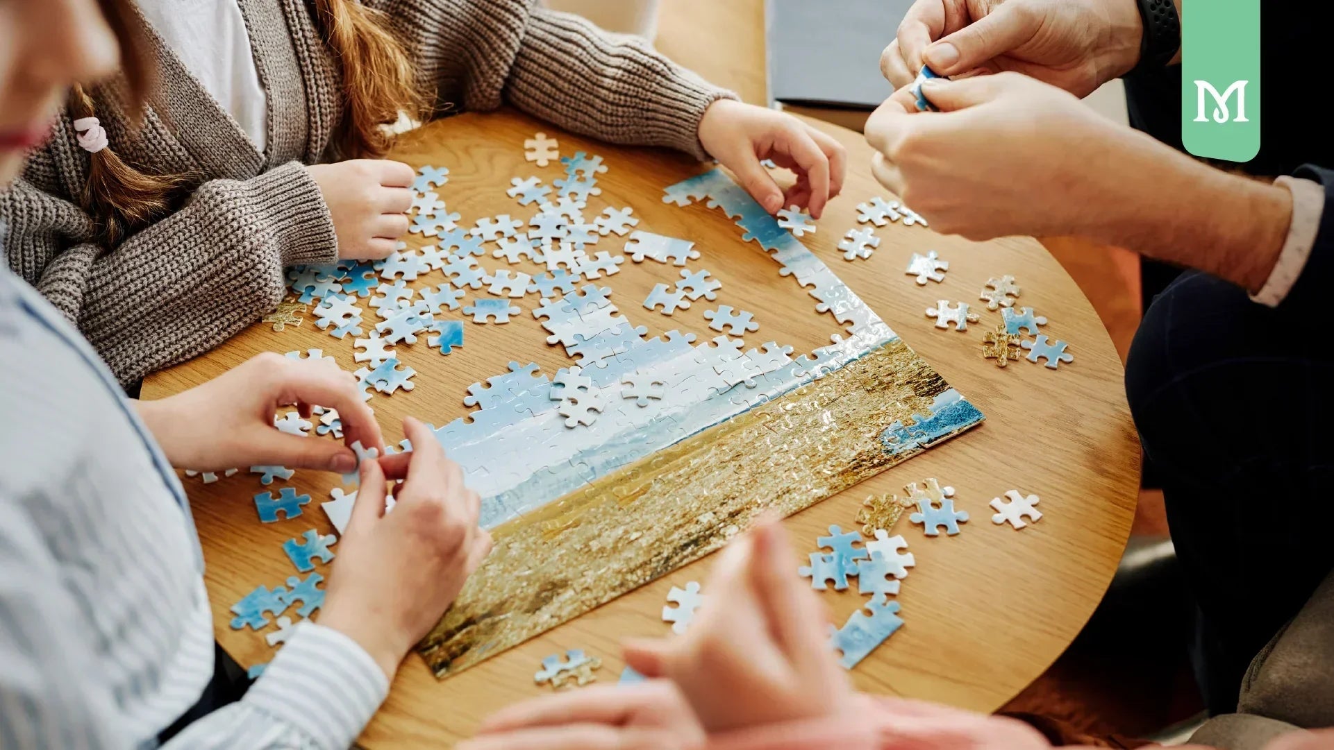 diferent hands on a table making a puzzle