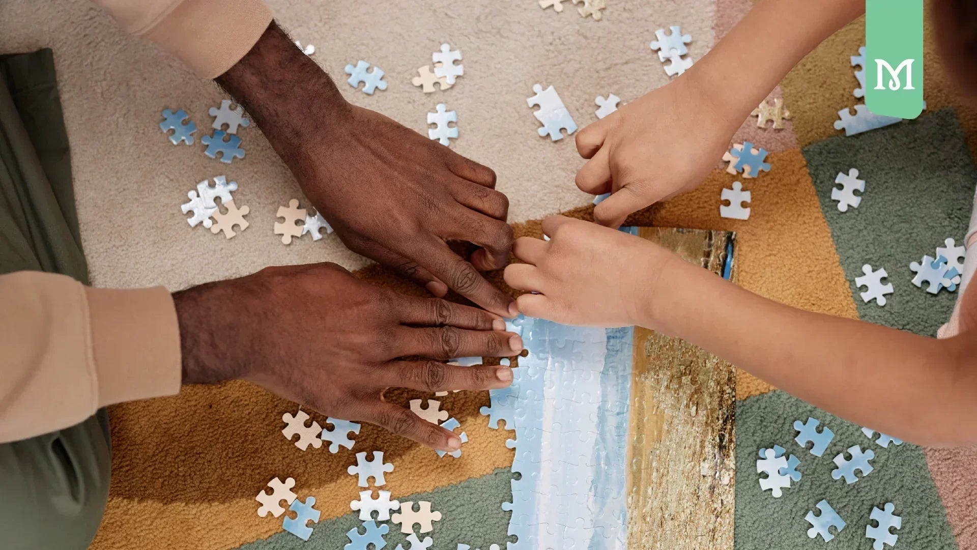 family hands solving a puzzle