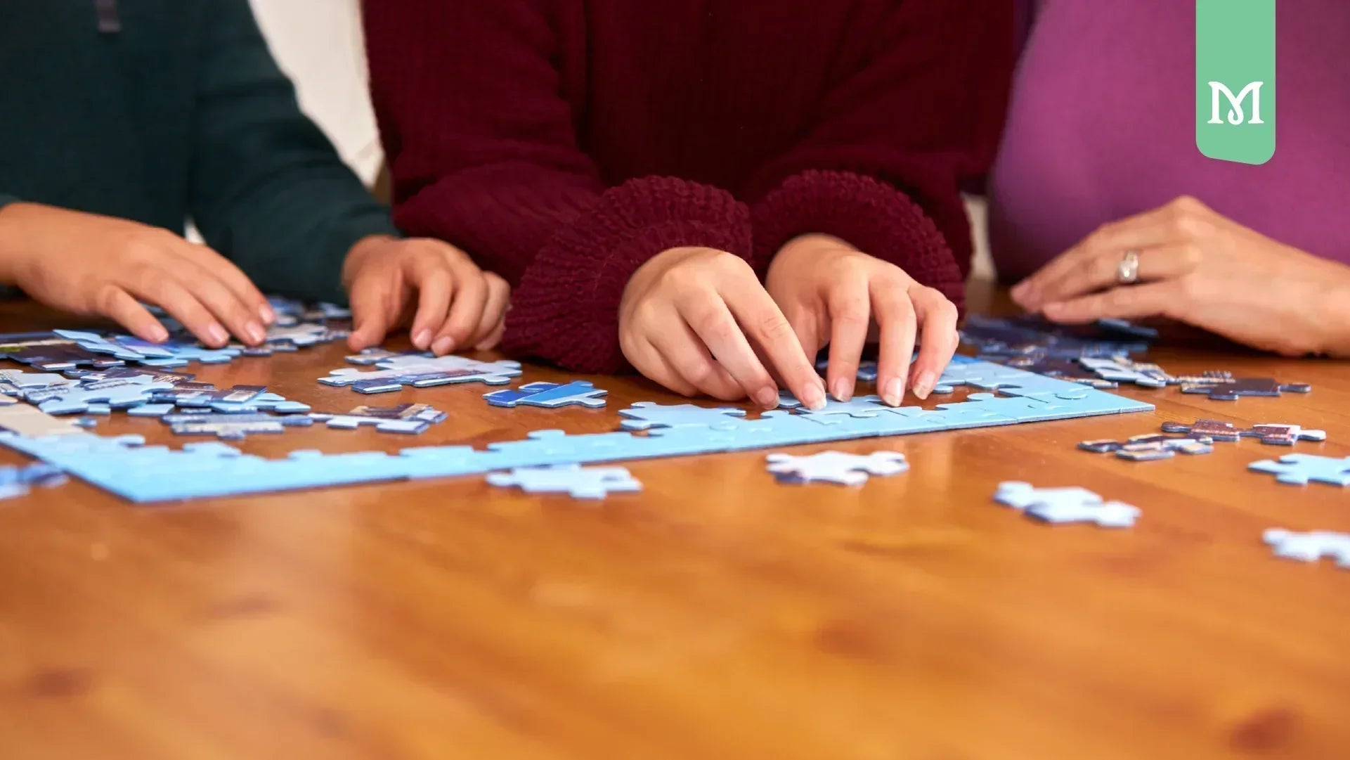 women hands solving a puzzle