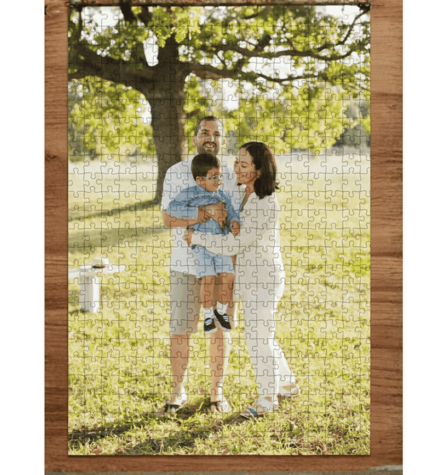 Jigsaw puzzle with a family photo on grass with trees