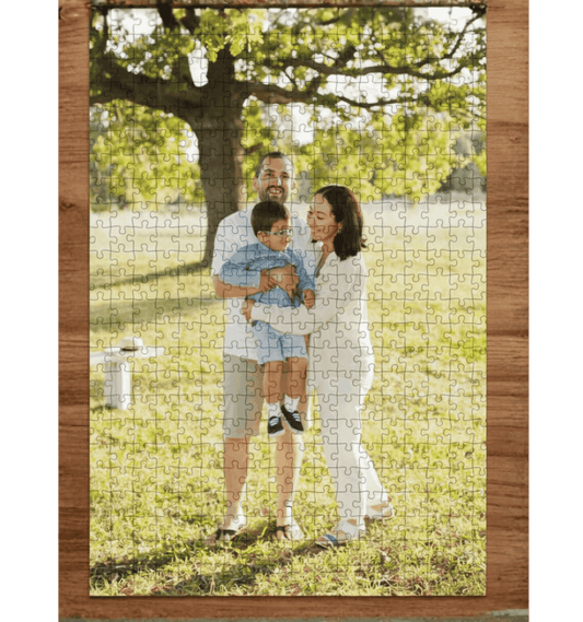Jigsaw puzzle with a family photo on grass with trees